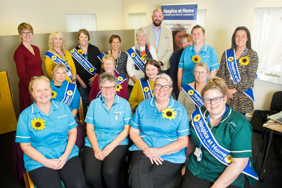 Staff and volunteers from Hospice at Home Carlisle and North Lakeland with the representative from the Cumberland