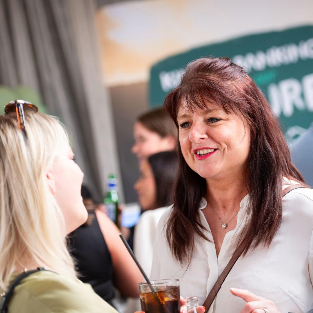 Cumberland colleagues having a conversation at an event