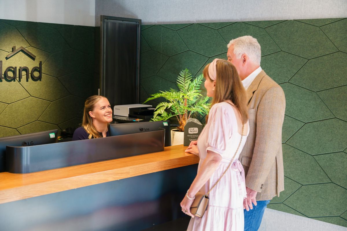 Cumberland colleague with customers at the desk in branch