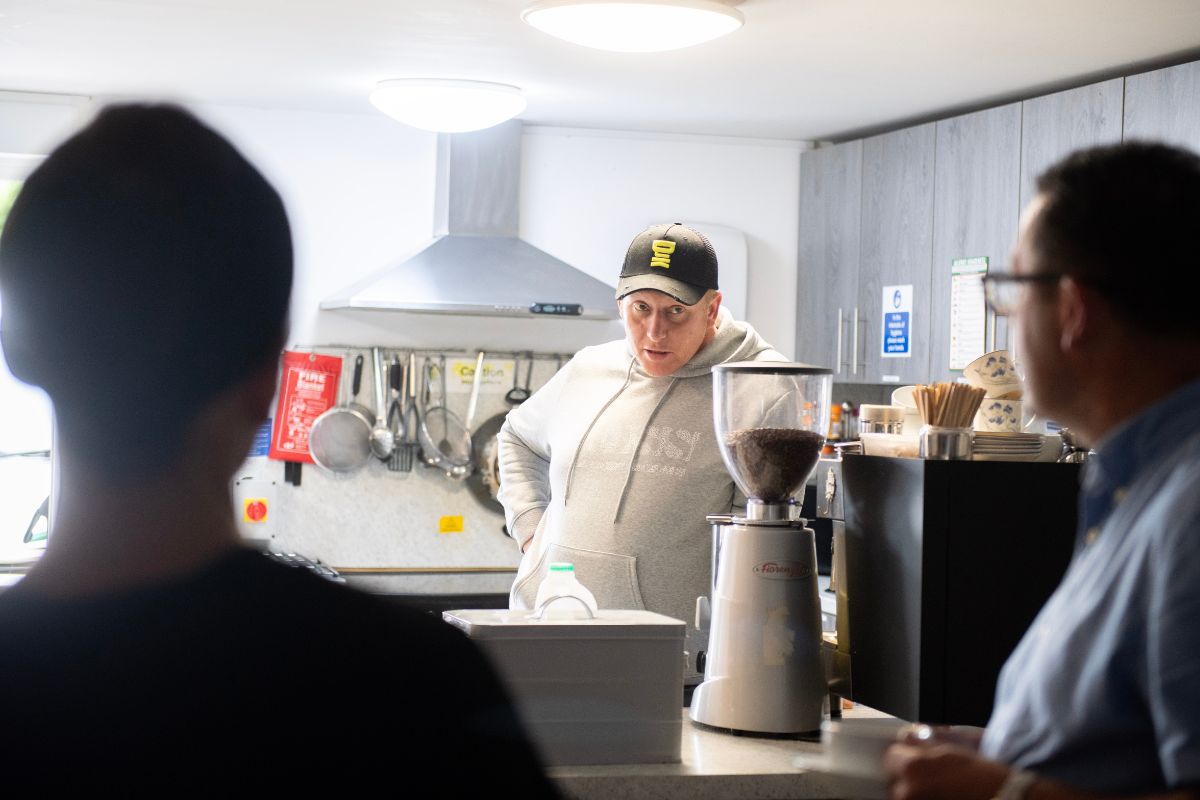 Cumberland staff and people from Calderwood House enjoying a cup of coffee.