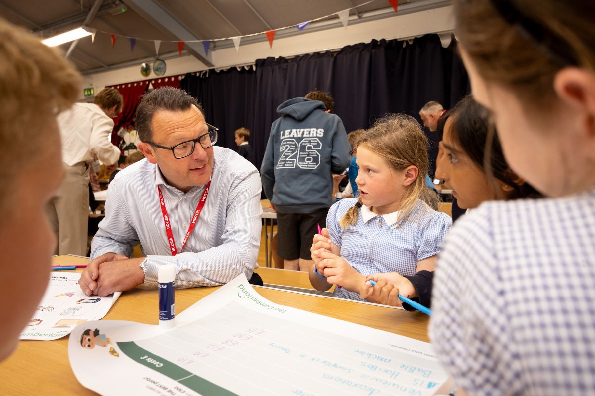 Stuart Miller, The Cumberland's chief executive, with pupils from Hayton Church of England Primary School